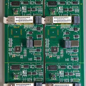 Four identical electronic circuit boards with various microcontrollers and other components.